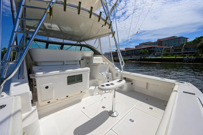 Slide: The Image of 2004 Pursuit 3800 Express yacht interior with seating and fishing rod holders. - 47