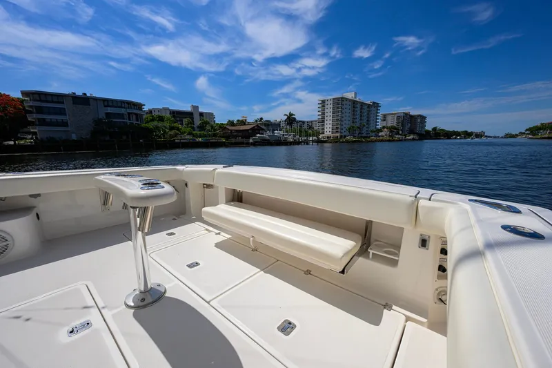Slide: The Image of 2004 Pursuit 3800 Express boat deck with waterfront view and clear blue sky. - 50