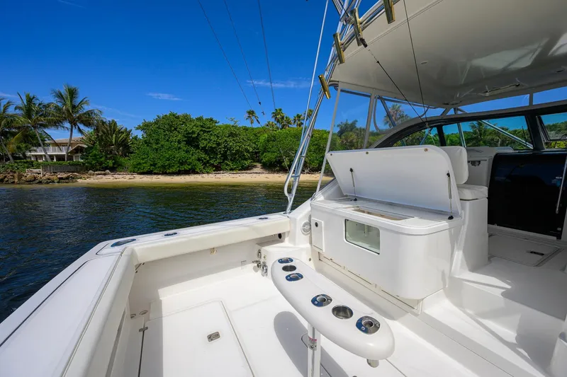 Slide: The Image of 2004 Pursuit 3800 Express boat interior with open hatch, near tropical shoreline. - 51