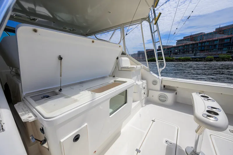 Slide: The Image of 2004 Pursuit 3800 Express boat interior with fishing rod holders and storage compartments. - 52