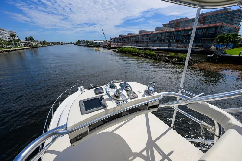 Slide: The Image of 2004 Pursuit 3800 Express yacht helm with waterfront view and modern controls. - 59