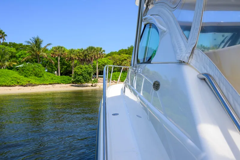 Slide: The Image of 2004 Pursuit 3800 Express yacht near tropical shoreline with lush greenery. - 63