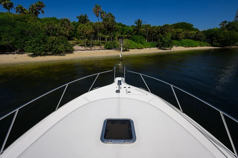 Slide: The Image of Bow view of 2004 Pursuit 3800 Express approaching a tropical shoreline. - 66