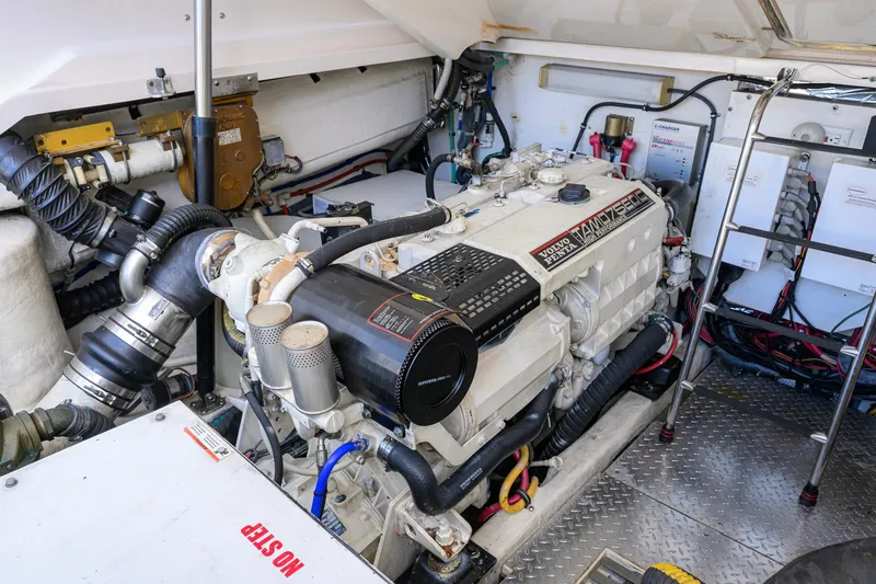 Slide: The Image of Engine room of a 2004 Pursuit 3800 Express boat, featuring a Volvo Penta engine. - 69