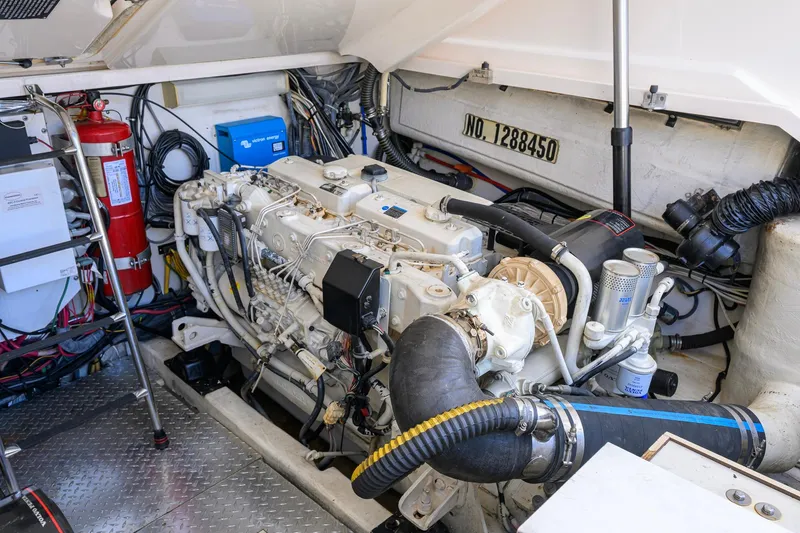 Slide: The Image of Engine room of a 2004 Pursuit 3800 Express boat, showcasing detailed machinery and components. - 70