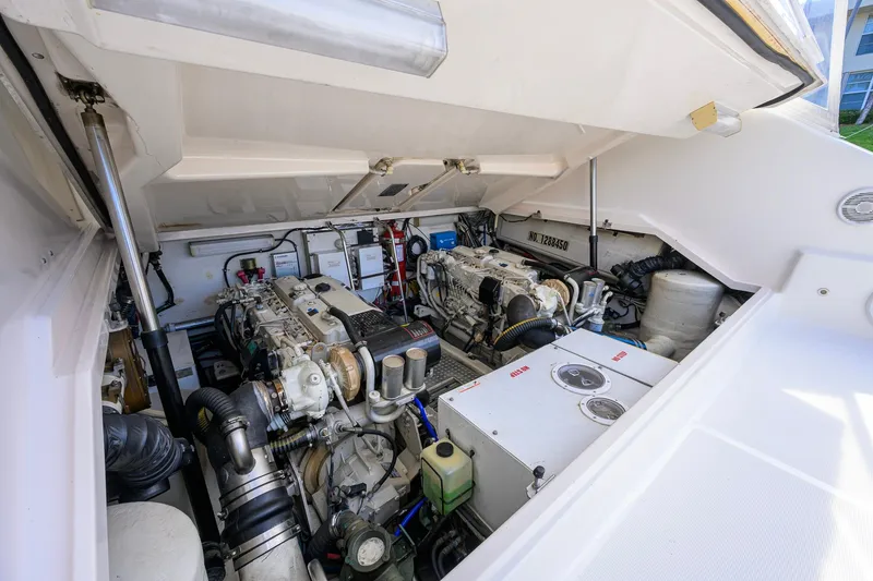 Slide: The Image of Engine compartment of a 2004 Pursuit 3800 Express boat, showcasing mechanical components. - 72