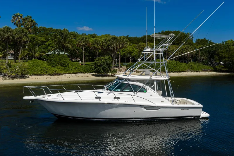 Slide: The Image of 2004 Pursuit 3800 Express boat on calm water near a tropical shoreline. - 9