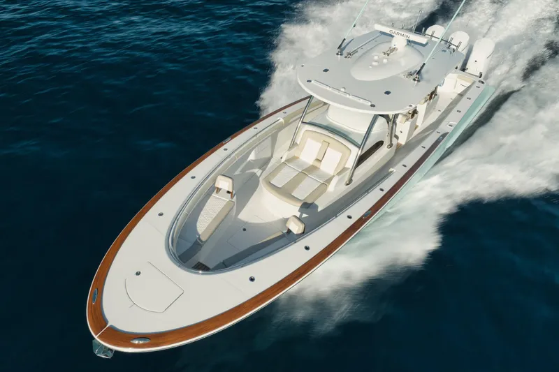 Slide: The Image of Manufacturer Provided Image: 2025 Mag Bay 43 CC boat cruising on open water, showcasing sleek design and luxury features. - 2