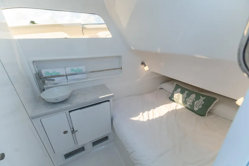 Slide: The Image of Manufacturer Provided Image: 2025 Mag Bay 43 CC cabin interior with bed, sink, and storage. - 8