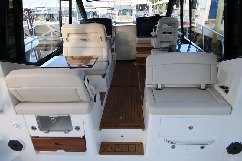 Slide: The Image of Manufacturer Provided Image: 2024 Boston Whaler 405 Conquest interior with white seating and wooden flooring. - 10