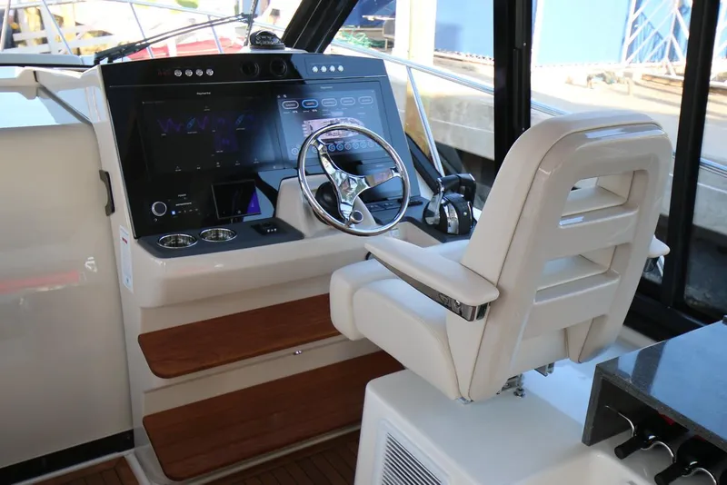Slide: The Image of Manufacturer Provided Image: 2024 Boston Whaler 405 Conquest helm station with modern controls and comfortable captain's chair. - 11