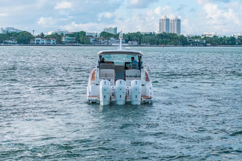Slide: The Image of 2024 Boston Whaler 405 Conquest cruising on a scenic waterway. - 4