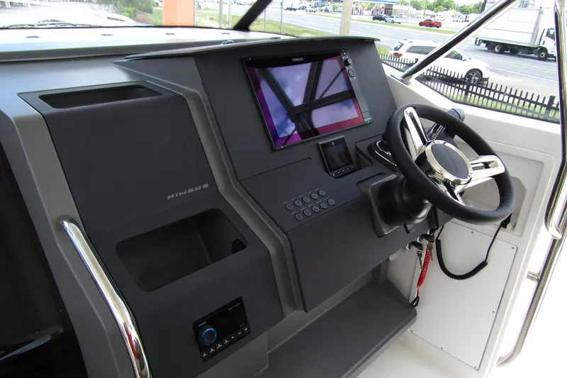 Slide: The Image of Helm of 2025 Nimbus Tender 11 with modern controls and steering wheel. - 13