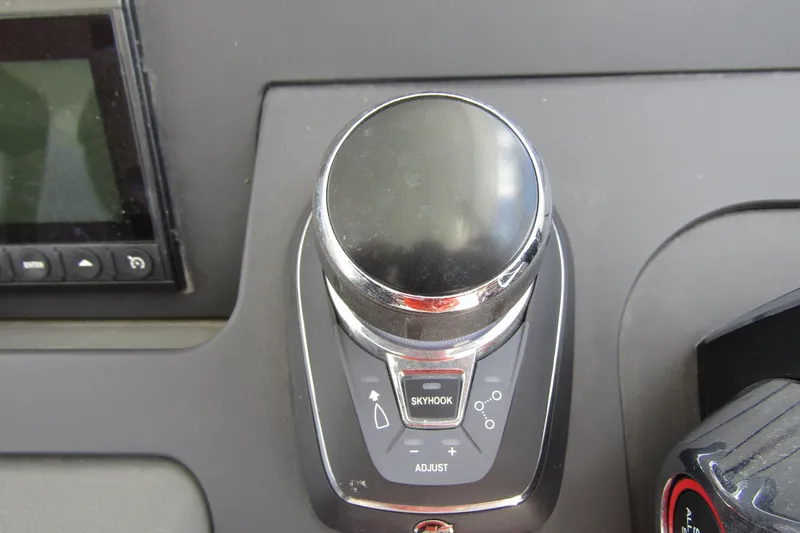 Slide: The Image of Control panel of 2025 Nimbus Tender 11 boat featuring joystick and Skyhook button. - 17