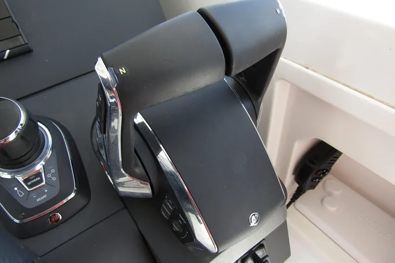 Slide: The Image of Control panel of 2025 Nimbus Tender 11 boat, featuring throttle and joystick controls. - 18