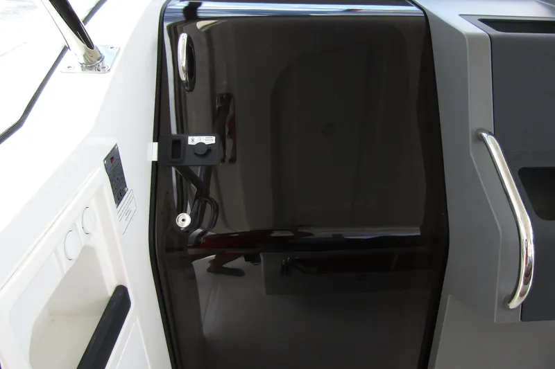 Slide: The Image of 2025 Nimbus Tender 11 boat interior with sleek black door and modern handle design. - 22