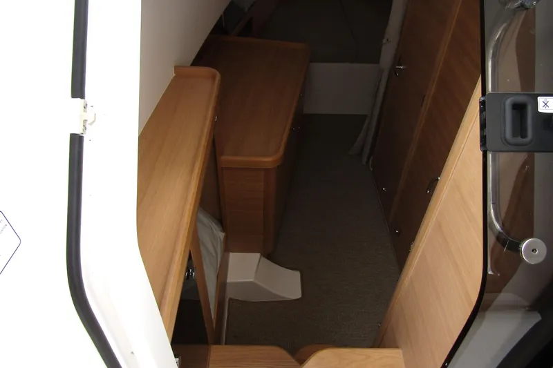 Slide: The Image of Interior view of 2025 Nimbus Tender 11, featuring wooden cabinetry and carpeted flooring. - 23