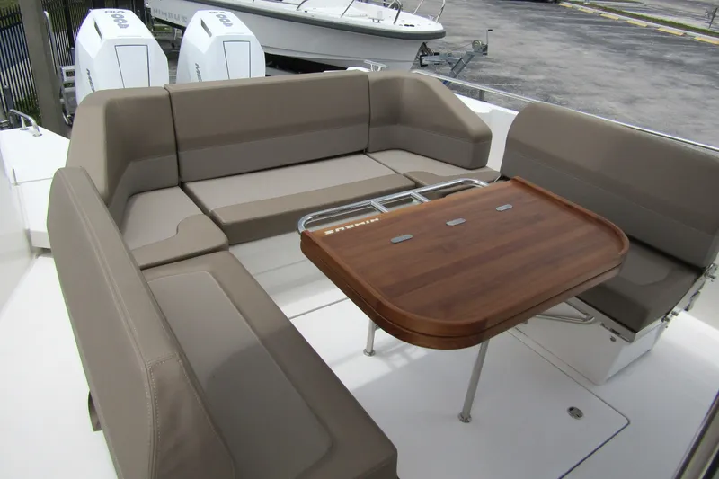 Slide: The Image of Luxurious seating area on 2025 Nimbus Tender 11 boat with wooden table. - 34
