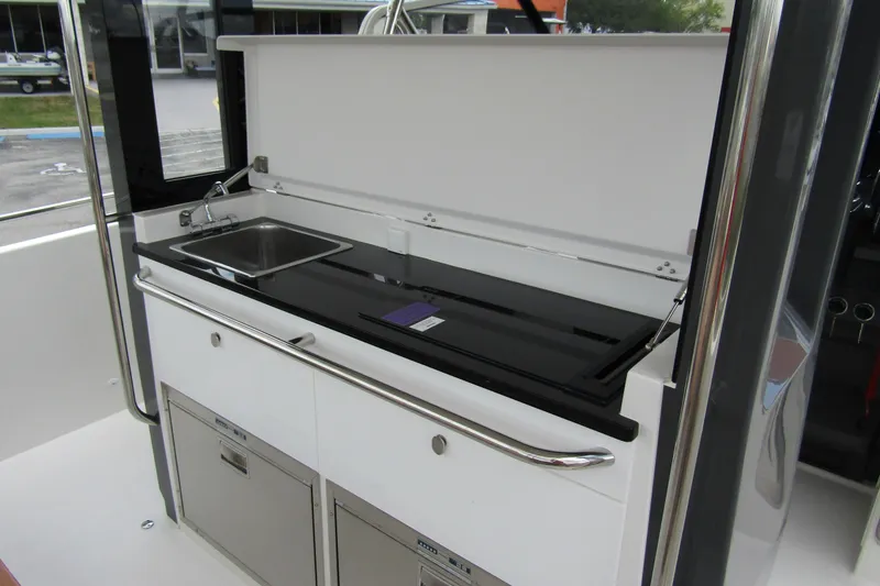 Slide: The Image of Modern kitchenette on 2025 Nimbus Tender 11 boat with sink and storage. - 37