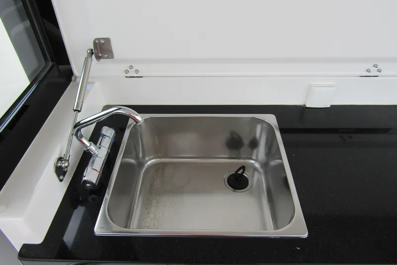 Slide: The Image of Stainless steel sink with modern faucet in 2025 Nimbus Tender 11 boat. - 39