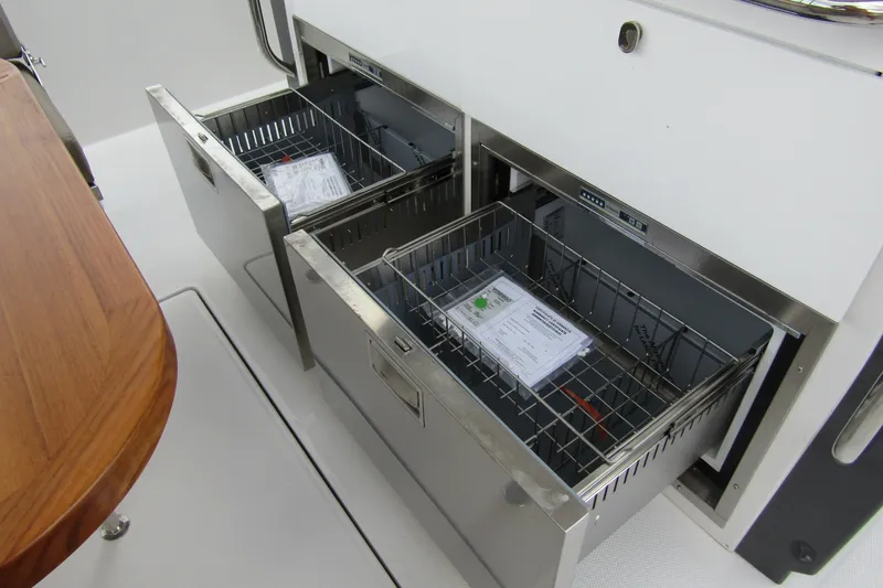 Slide: The Image of Stainless steel storage drawers on 2025 Nimbus Tender 11 boat interior. - 41