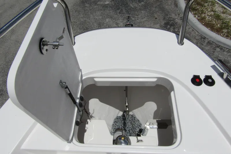 Slide: The Image of Anchor compartment of 2025 Nimbus Tender 11 boat, featuring chain storage and secure latch. - 8