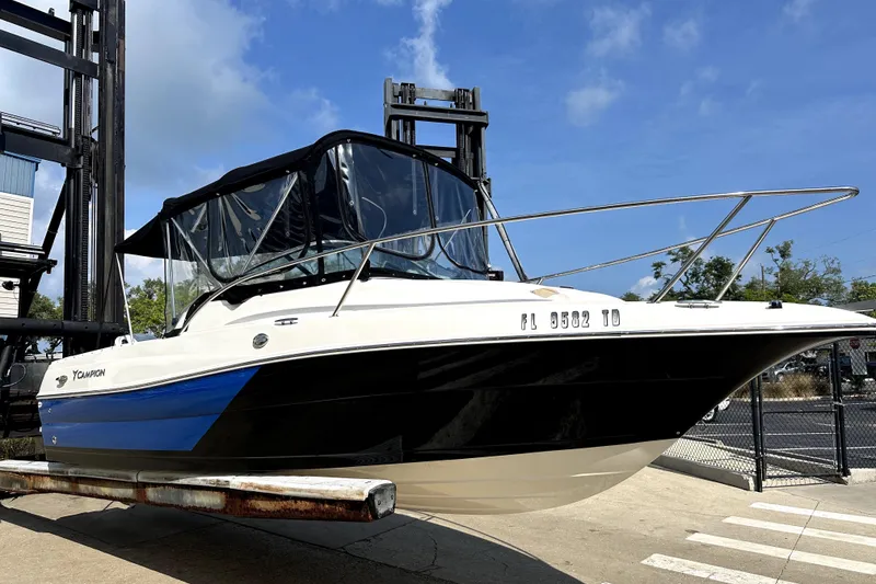 The Image of 2021 Campion A21 boat with blue and black hull on a lift under clear skies. - 1
