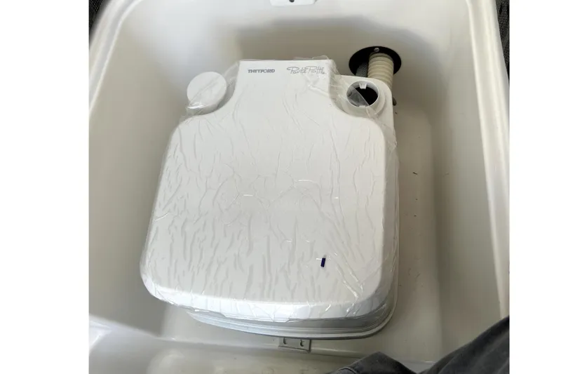 Slide: The Image of Portable toilet in a 2021 Campion A21 boat, featuring a compact design. - 12