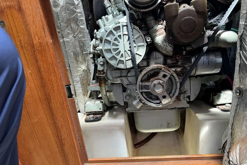 Slide: The Image of Engine compartment of a 2001 Catalina 34 MkII sailboat, showing mechanical components. - 24