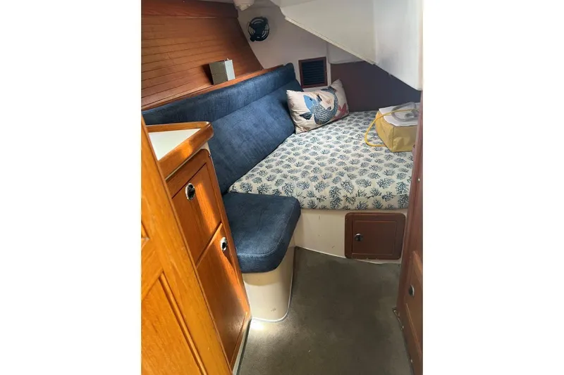 Slide: The Image of Cozy cabin interior of 2001 Catalina 34 MkII sailboat with blue seating and patterned bedding. - 19