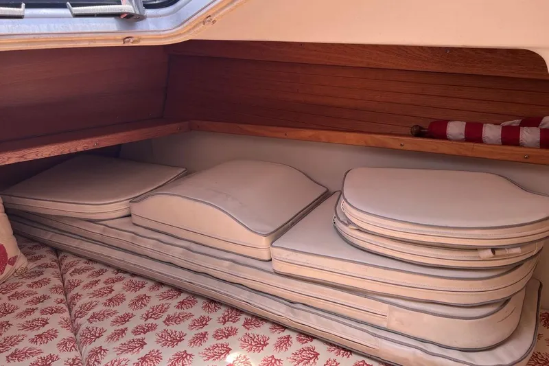 Slide: The Image of Interior cabin of 2001 Catalina 34 MkII sailboat with stacked cushions and wooden paneling. - 22
