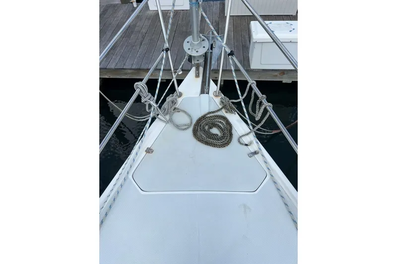 Slide: The Image of Bow of 2001 Catalina 34 MkII sailboat with ropes and dock in view. - 5