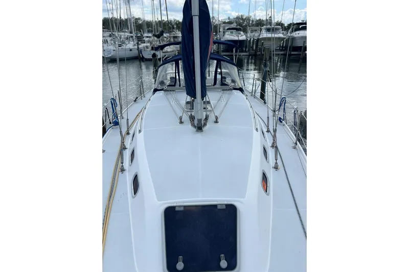 Slide: The Image of 2001 Catalina 34 MkII sailboat docked at a marina, showcasing its deck and rigging. - 6