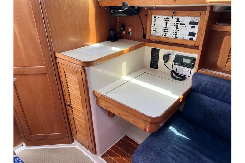Slide: The Image of 2001 Catalina 34 MkII yacht interior with navigation station and control panel. - 16