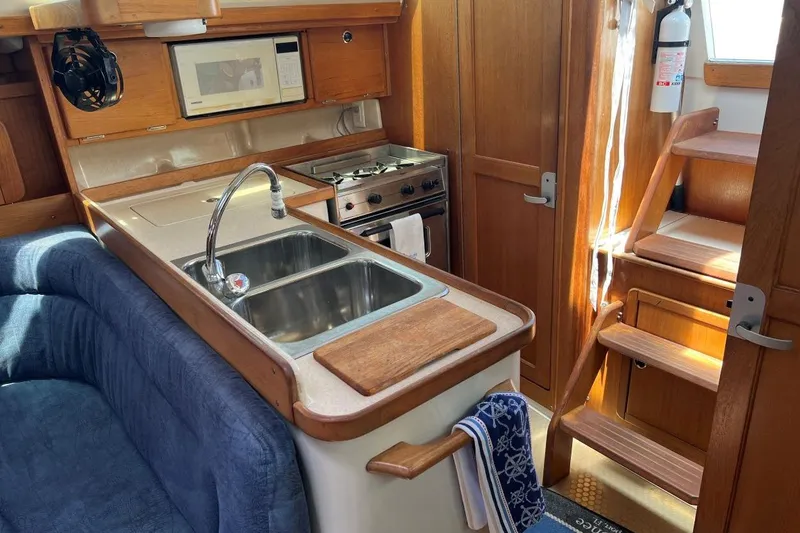 Slide: The Image of Interior of 2001 Catalina 34 MkII sailboat with kitchen and wooden cabinetry. - 13