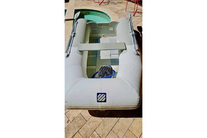 Slide: The Image of Inflatable dinghy on tiled patio, associated with 2001 Catalina 34 MkII sailboat. - 25