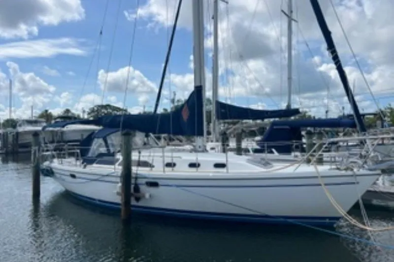 Slide: The Image of 2001 Catalina 34 MkII sailboat docked at marina under blue sky. - 2