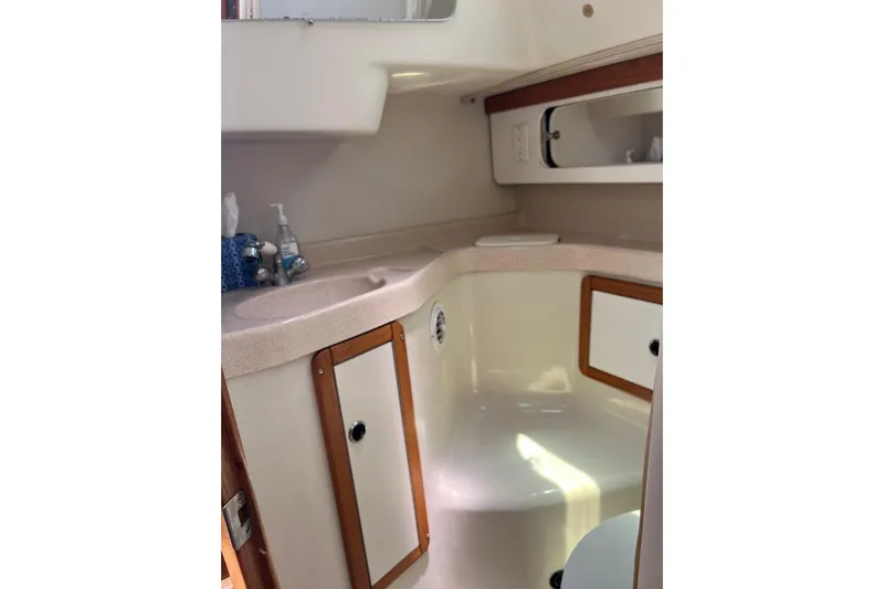Slide: The Image of Interior of 2001 Catalina 34 MkII sailboat bathroom with sink and storage cabinets. - 20