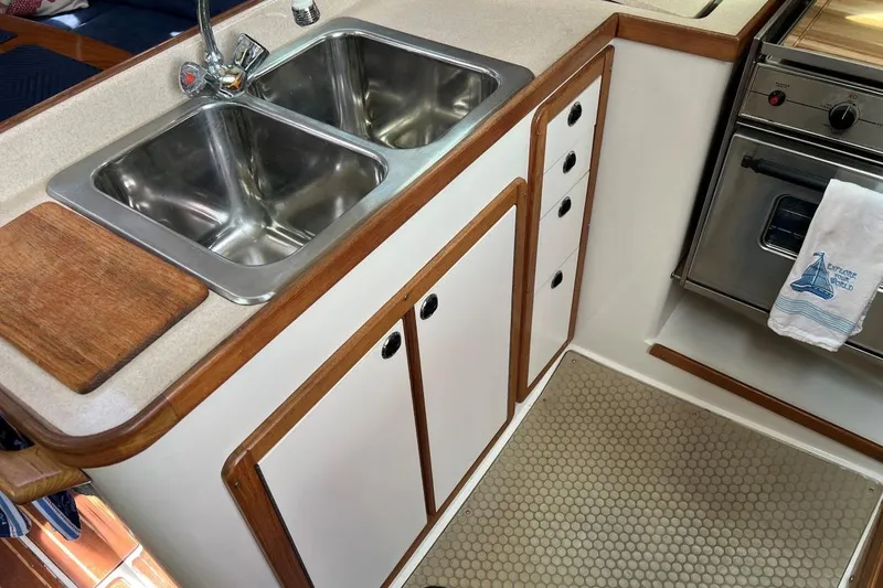 Slide: The Image of Galley kitchen in 2001 Catalina 34 MkII sailboat with double sink and stove. - 14