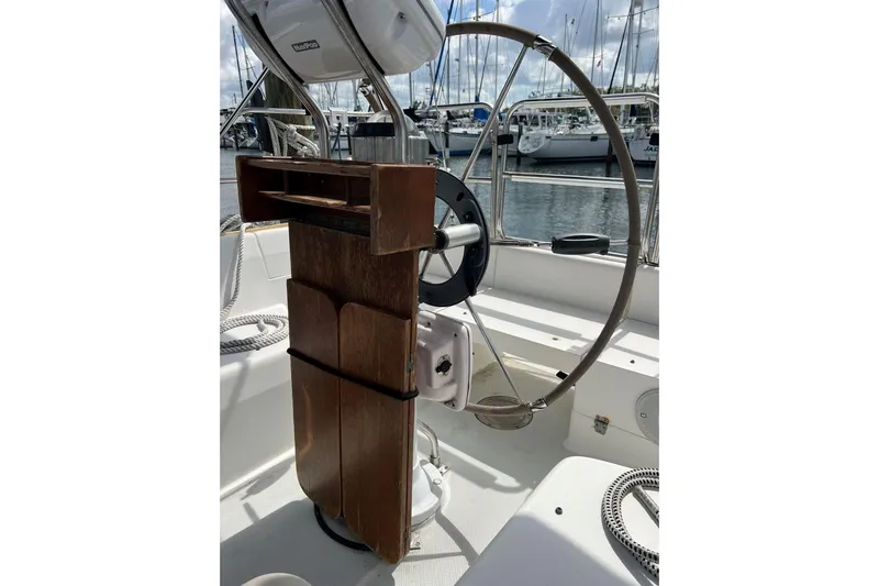 Slide: The Image of Steering wheel of a 2001 Catalina 34 MkII sailboat in a marina setting. - 8