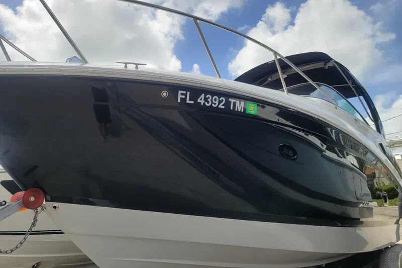 The Image of 2023 Regal 26 XO boat with Florida registration, sleek black hull, and stainless steel railings. - 0