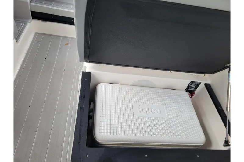 Slide: The Image of Storage compartment with Igloo cooler on 2023 Regal 26 XO boat. - 13