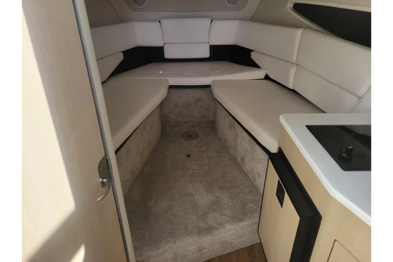 Slide: The Image of Interior cabin of 2023 Regal 26 XO boat with plush seating and compact kitchenette. - 14
