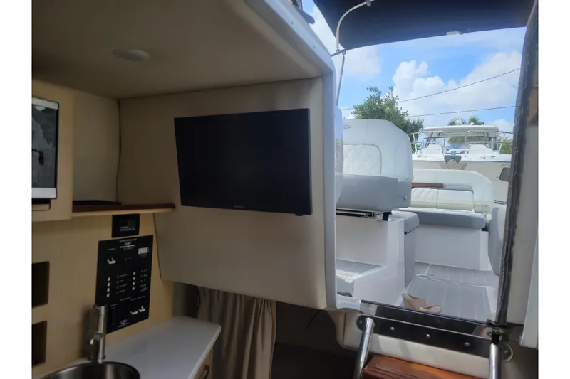 Slide: The Image of Interior view of 2023 Regal 26 XO boat with TV and seating area. - 16
