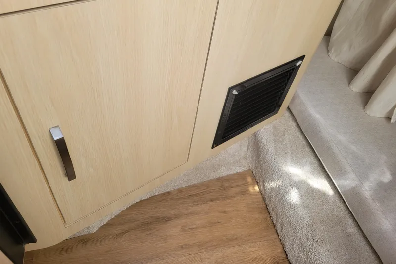 Slide: The Image of Interior of 2023 Regal 26 XO boat showing wooden cabinet and vent. - 17