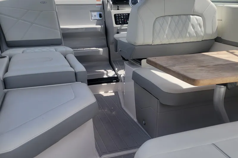Slide: The Image of Interior of 2023 Regal 26 XO boat with luxurious seating and wooden table. - 2