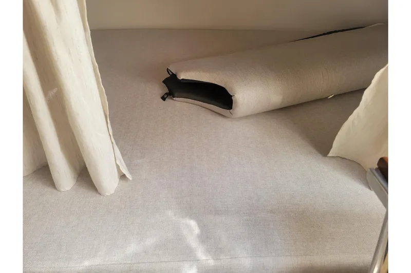 Slide: The Image of Interior cabin of 2023 Regal 26 XO boat with beige upholstery and curtain. - 20