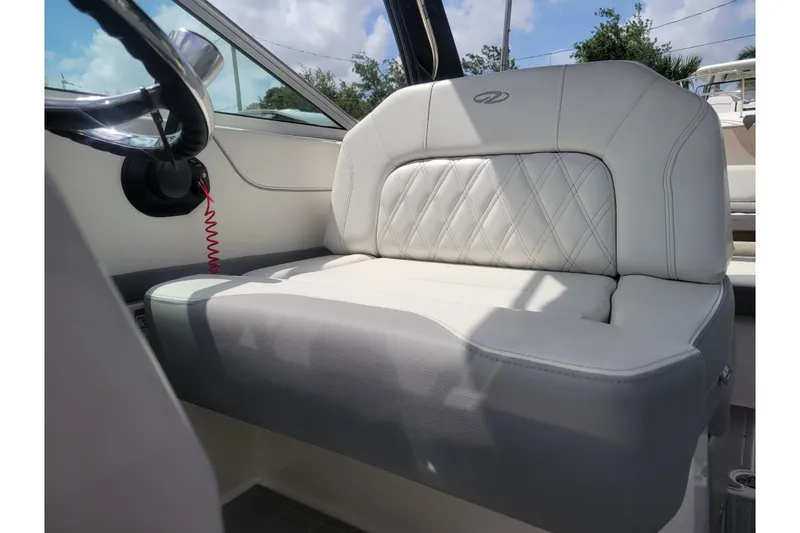 Slide: The Image of 2023 Regal 26 XO boat interior with plush seating and steering wheel. - 4