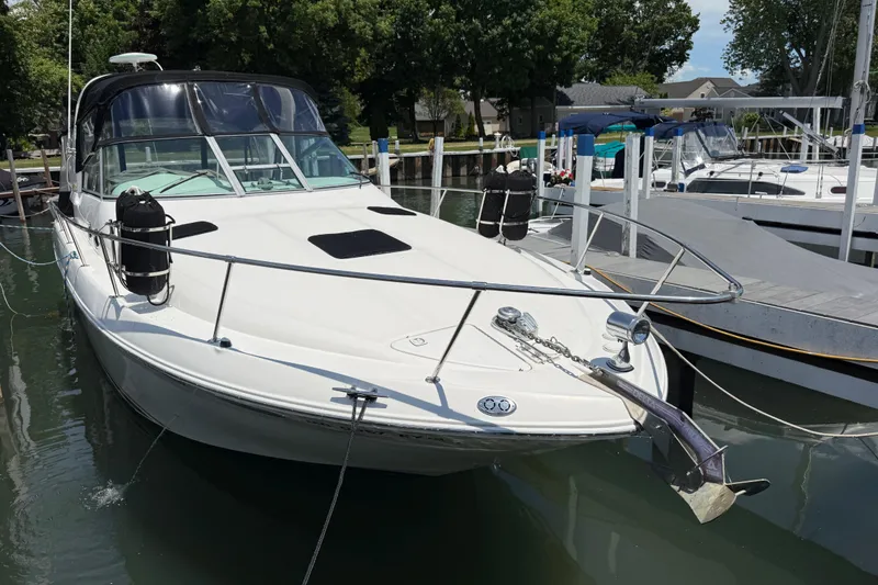 The Image of 1999 Sea Ray Sundancer 310 docked at marina, featuring sleek design and spacious deck. - 0