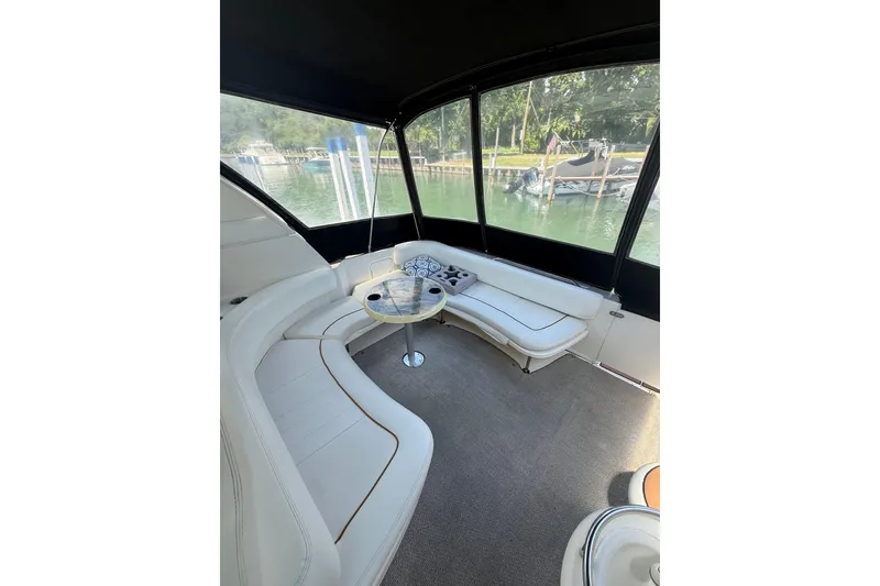 Slide: The Image of Interior of 1999 Sea Ray Sundancer 310 yacht with white seating and table. - 11
